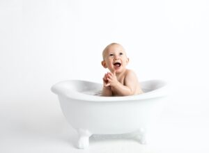 baby in bathtub smiling